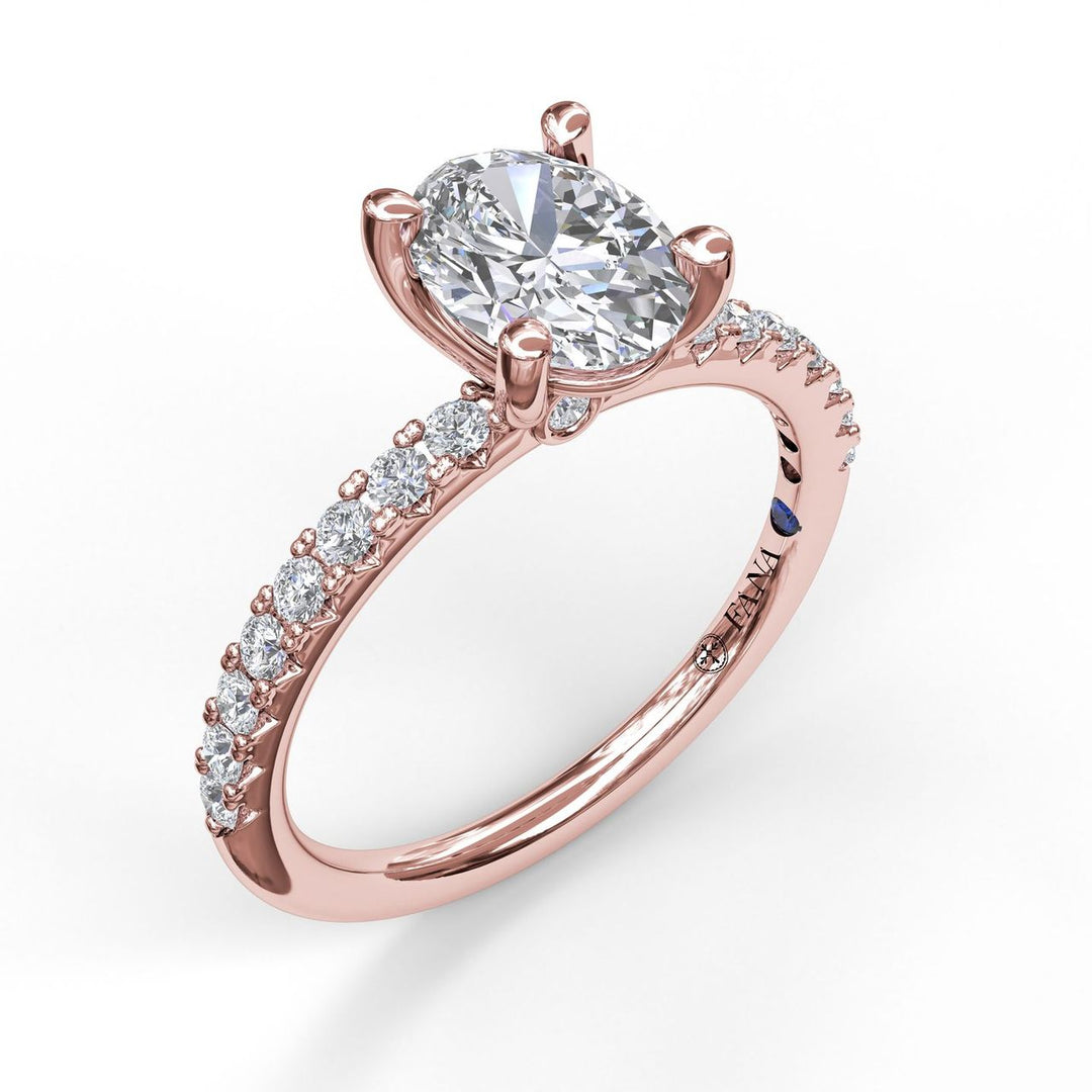 Classic Single Row Engagement ring with an Oval Center Diamond.